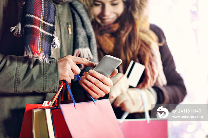 Adult couple shopping in the city during Christmas time