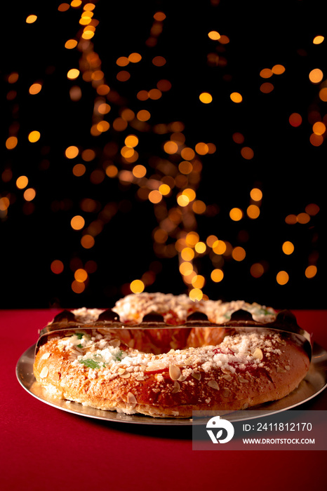 Spanish typical epiphany cake  Roscon de Reyes , and christmas light