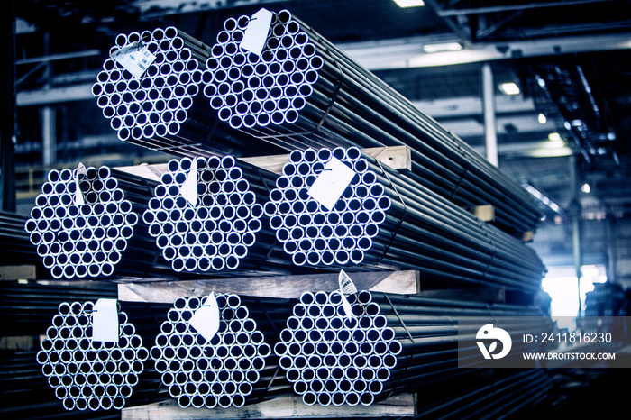 Stacks of metal pipes on shelf in warehouse