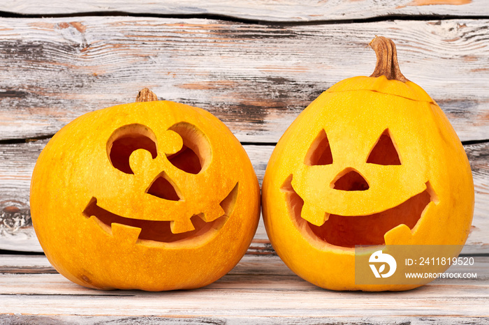 Funny Halloween pumpkin on wooden background. Preparation for Halloween. Head carved from a pumpkin 