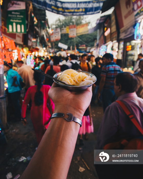 Hand holding indian food