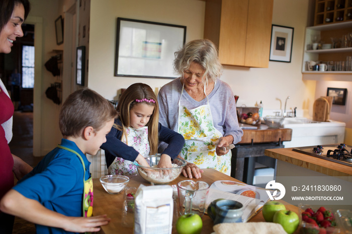 Multigenerational family preparing food in kitchen