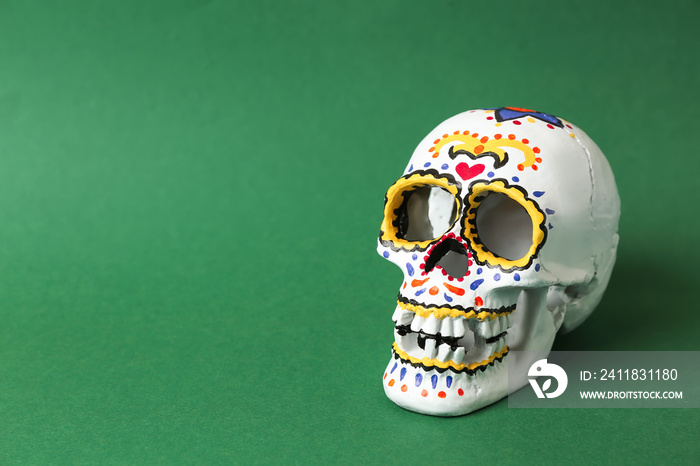 Painted human skull for Mexicos Day of the Dead on color background