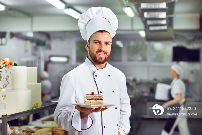 A confectioner with dessert in his hands in the bakery.