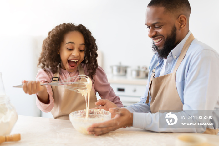 Happy family mixing dough cooking pie together in kitchen