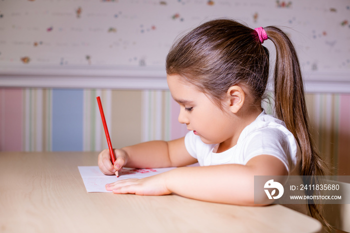 little girl at home writes draws, classes for a child at home