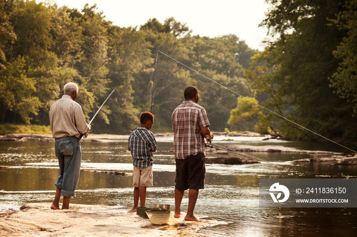 Multigenerational family fishing in river