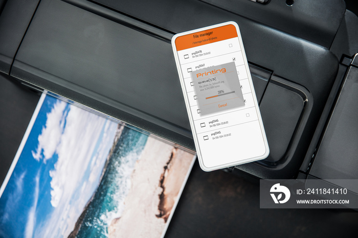 Smartphone connected with wireless photo printer sending file to print