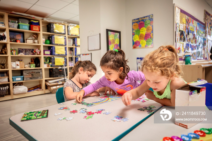 Girls working on puzzle