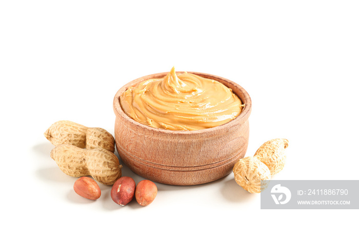 Creamy peanut butter in glass bowl and peanut isolated on white background. A traditional product of