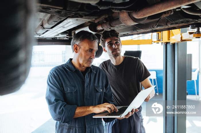 Technicians working in auto service station