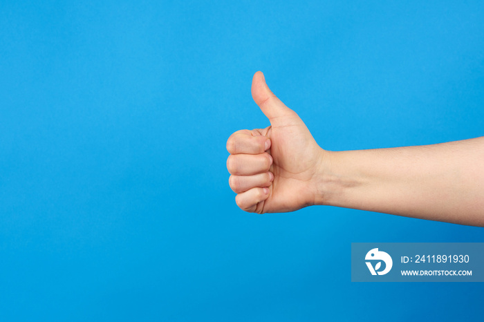 female hand shows right-handed gesture like on a blue background