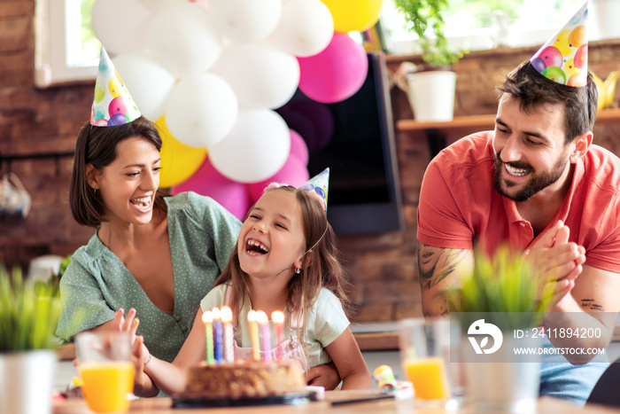 Young family celebrating birthday.