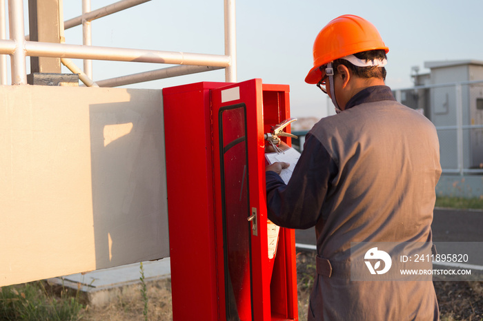 Safety officials checking a fire extinguisher