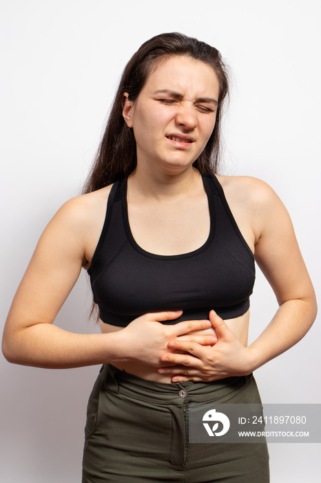 A womans stomach hurts. Abdominal pain due to gastritis, stomach ulcers and Crohns disease. Gastro