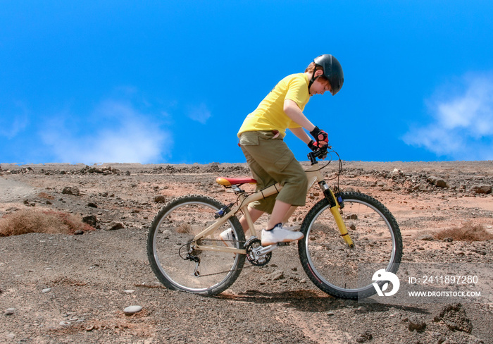 boy riding his mountainbike offroads