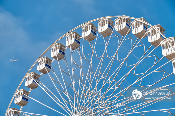 Ferris wheel and a plane. Lisbon, Portugal.