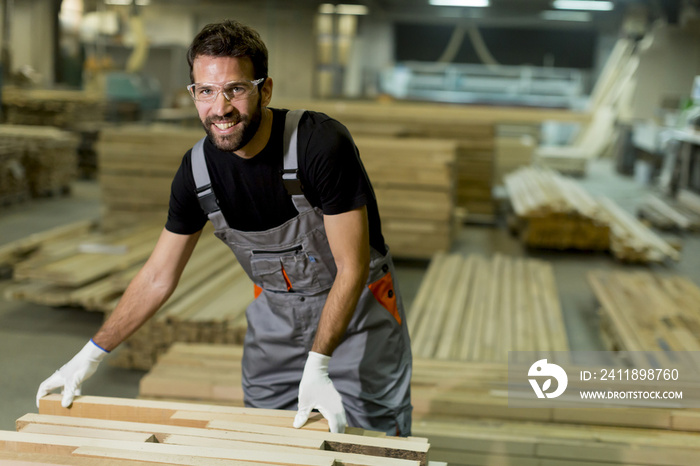 Handsome young man working in the lumber factory