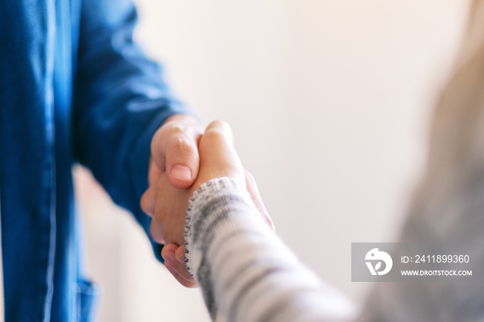 Closeup image of two people shaking hands