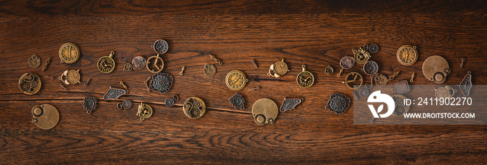 Mechanical cogwheel elements on a dark wooden surface