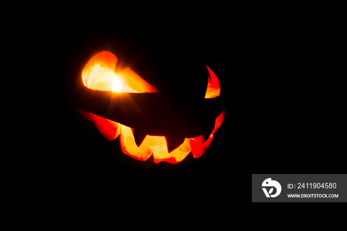 Glowing eyes and mouth of halloween pumpkin (Jack o lantern) on black background. Halloween