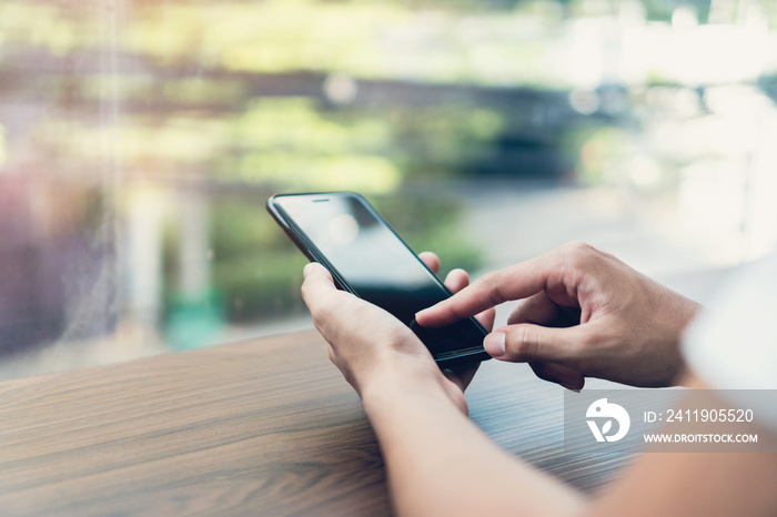 Man hand using black smartphone blank screen on isolated. Take your screen to put on advertising.