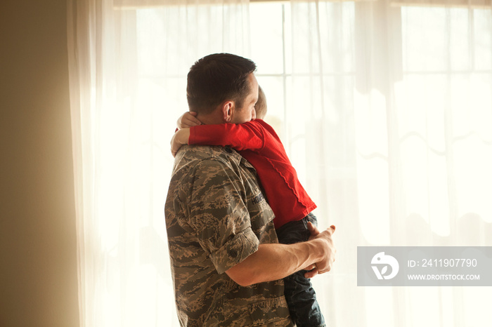 Father carrying his son at home