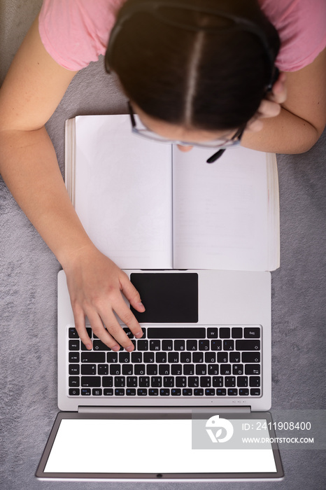 Social distancing student concept, education at home. High school girl doing homework at home with l