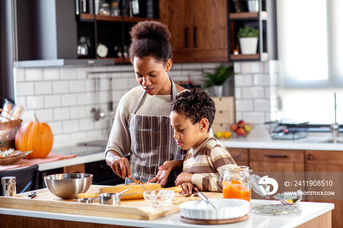 Woman prepare pie in the kitchen and learn his son cooking