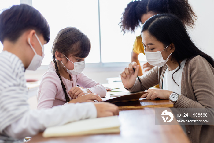 A group of Kids students wearing medical masks in the classroom.