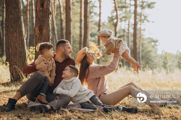 Young family with children having picnic in park