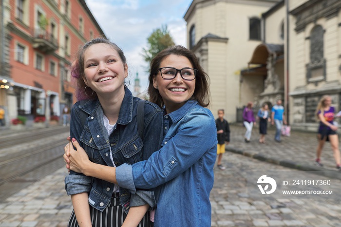 Relationship parent and teenager, hugging smiling mother and daughter