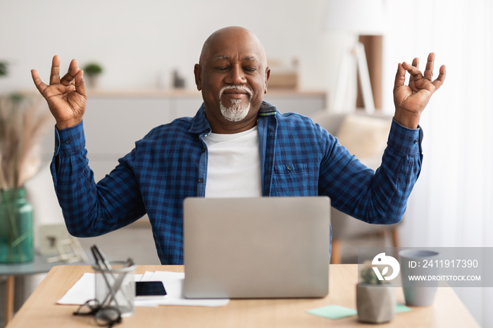 Peaceful Senior Black Man Meditating Sitting At Laptop At Workplace