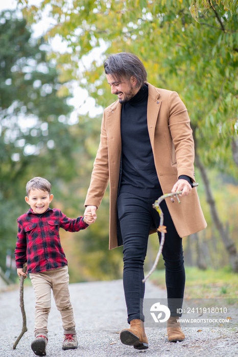 Happy family father and son walking outside