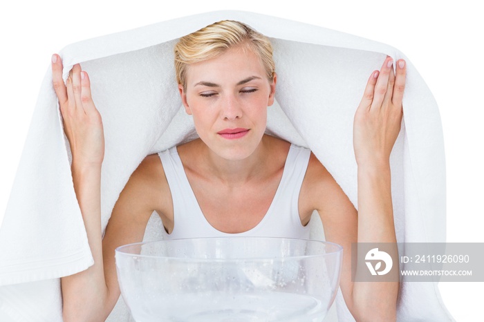 Blonde woman inhaling herbal medicine