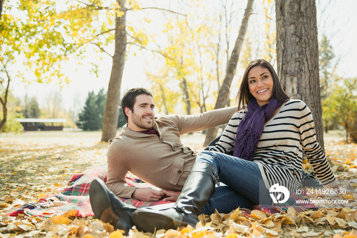 Happy young couple relaxing in park