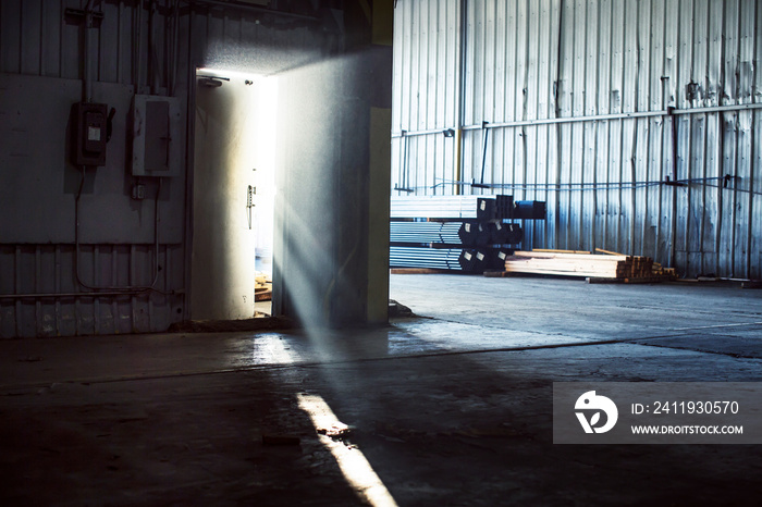 Warehouse door ajar in sunlight