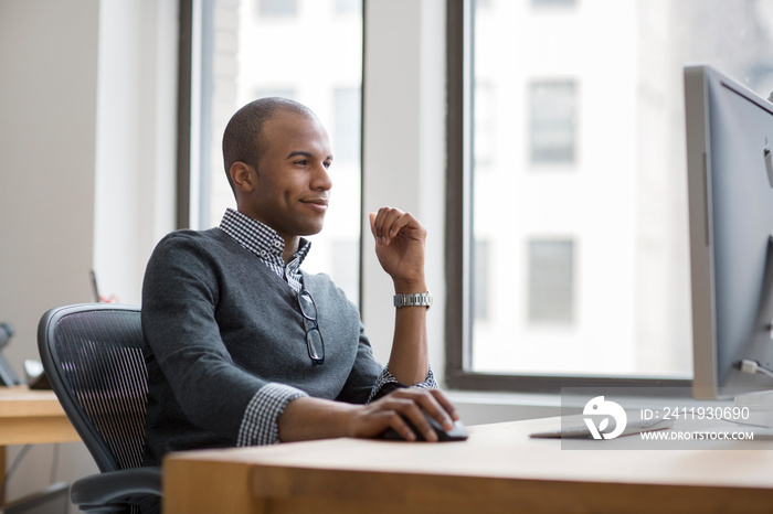 Young man working on computer in office