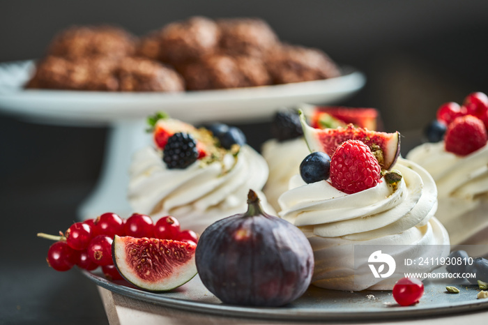 Mini Pavlova cake meringue dessert decorated with berries