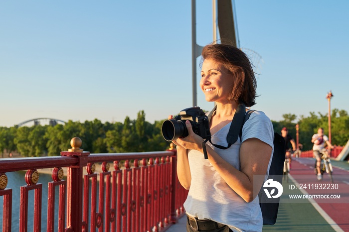 Mature woman photographer with camera taking photo picture