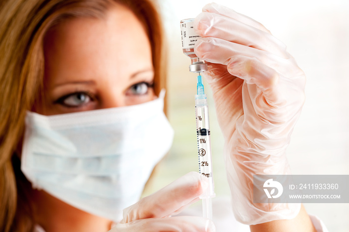 Flu: Inserting Syringe Needle Into Vaccine Vial