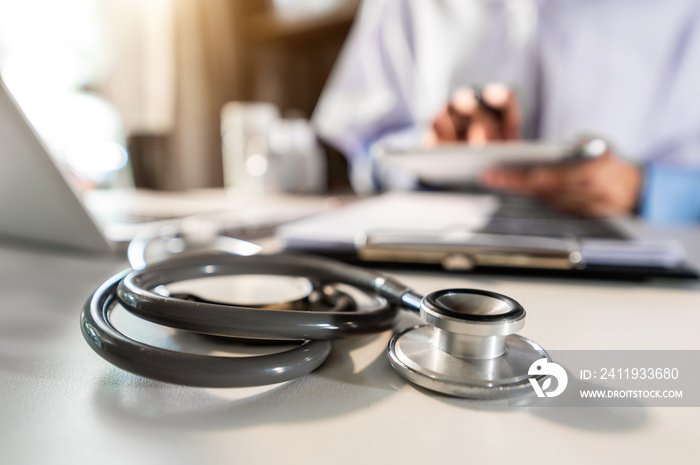 Medical technology concept. Doctor working with mobile phone and stethoscope in modern office