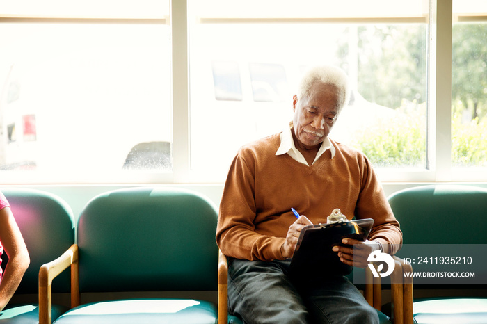 Senior man filling in documents