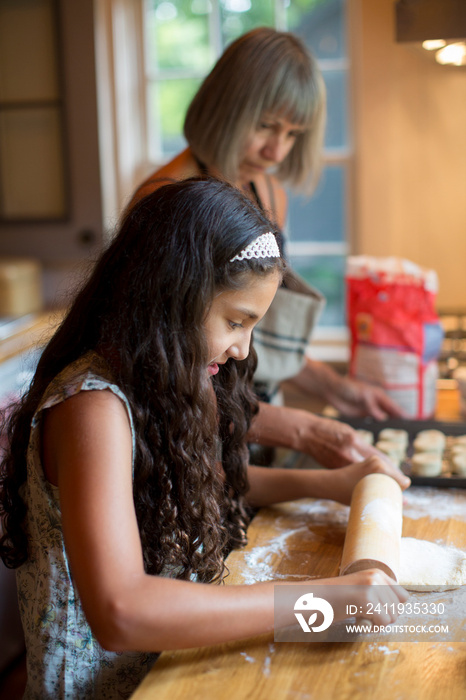 Grandmother baking with granddaughter (8-9)