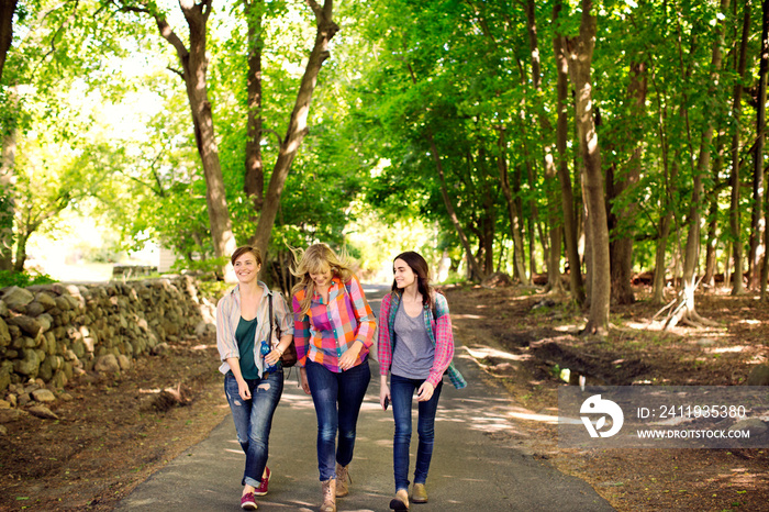 Three young women walking in park