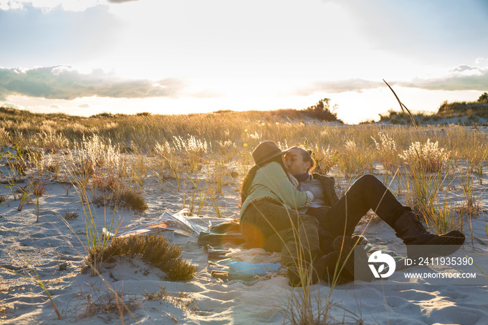 Couple kissing on sand dune