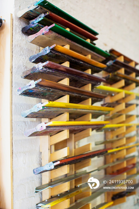 Colorful planks drying on shelf