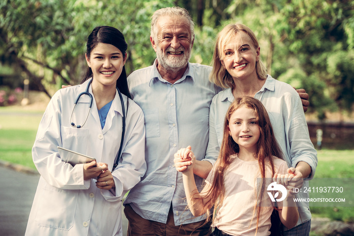 Happy healthy family and doctor talking in the park. People healthcare and medical staff service con