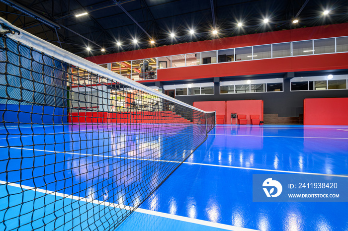 Blue colored empty indoor tennis court