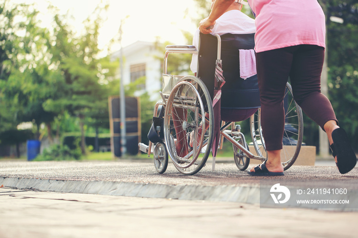 Senior couple with wheelchair in city